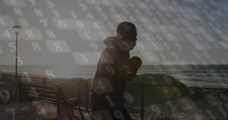 Practicing shadowboxing man in hoodie and gloves on boardwalk at sunrise, data overlay, copy space