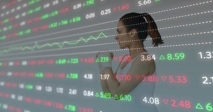 Female athlete fastening hand wraps over sports top in studio, with stock data overlay, copy space - Powered by Adobe