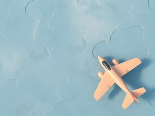 Close-up of a small yellow toy airplane flying on a light blue textured surface overhead