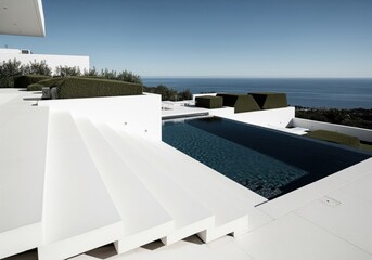 Minimalist white architecture steps leading to a dark infinity pool with ocean view