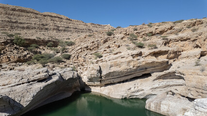 Wadi Bani Khalid is a popular Omani oasis featuring large, swimmable emerald-green pools and canyon landscapes in Oman.