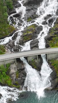 Vertical aerial shot of Langfossen waterfall in Norway