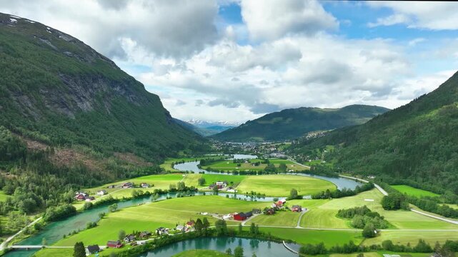 Aerial of a river winding through meadows and farmland near the town of Stryn Norway.