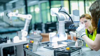 robotics engineer in an R&D lab performs diagnostics on an AI-driven collaborative robot (cobot). She is inspecting the hardware and system sensors.