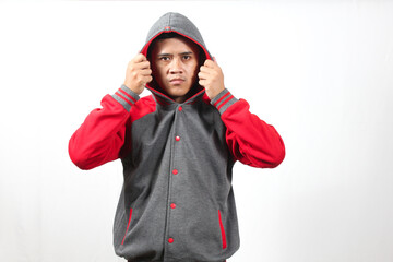 man wearing a red and grey varsity jacket with a hood, isolated on a white background.