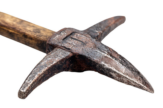 Close up of an ancient metal pickaxe head with a wooden handle