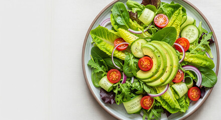 Fresh Green Salad with Avocado, Tomatoes, Cucumber, and Red Onion on Plate