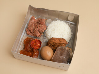 Rice with egg, fried noodle, chili sambal, and tofu