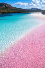 Stunning view of vibrant pink lake merging with turquoise waters, surrounded by lush greenery and mountains under bright blue sky