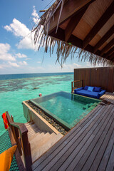 Tranquil closeup calm sea water waves with infinity pool bungalow. Summer vacation, holiday amazing nature. Relax paradise, Maldives. Tropical island beach landscape exotic shore coast. 