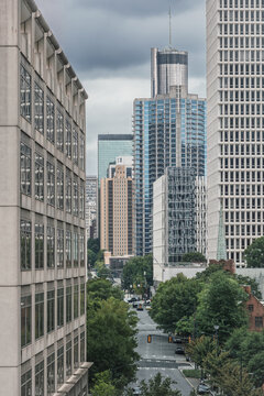 View of the Midtown Atlanta showing a street, several prominent buildings, roads, cars and hotels under a cloudy sky.