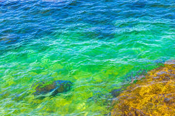 Rock rocks boulder boulders in turquoise green blue water Brazil.