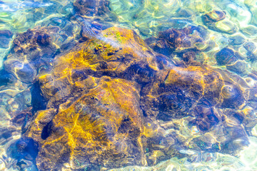 Rock rocks boulder boulders in turquoise green blue water Brazil.
