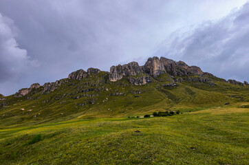 Fototapeta premium Hiking in the Italian Alps. The Roda de Putia hiking route in the Dolomites. The trail to Mount Peitlerkofel. Colorful landscapes of the mountain range, hiking trails, and huts nearby.