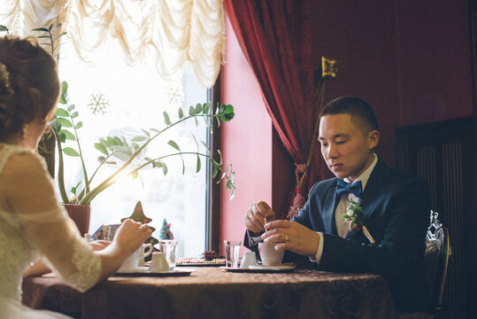 groom enjoying coffee after wedding ceremony