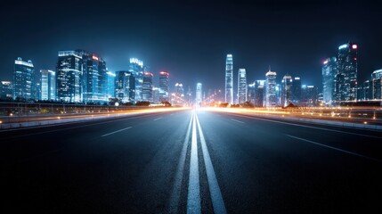 Asphalt road leading towards lit up skyscrapers at night