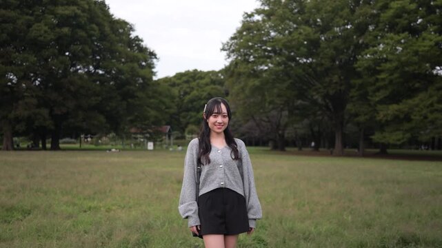 Slow motion dolly-out portrait of a smiling woman in the par