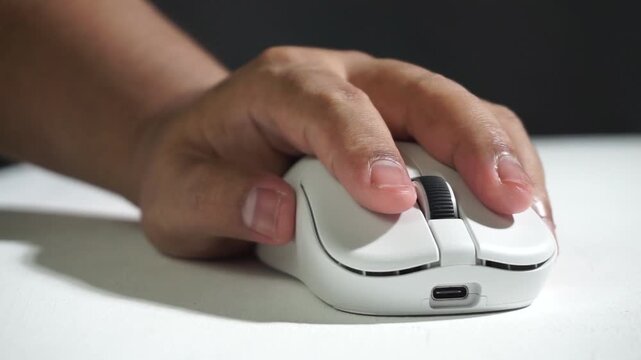 Repeated clicking of a white computer mouse, macro shot emphasizing tactile motion, productivity concept, digital interaction closeup.