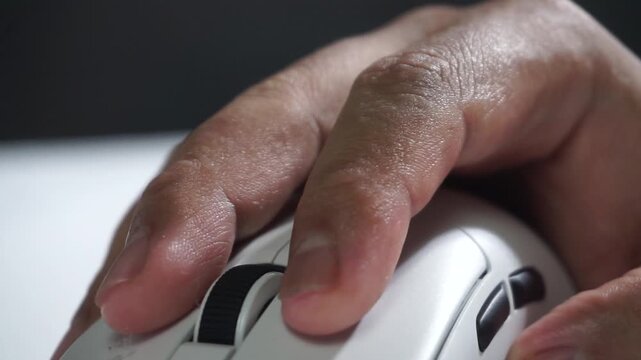 Repeated clicking of a white computer mouse, macro shot emphasizing tactile motion, productivity concept, digital interaction closeup.