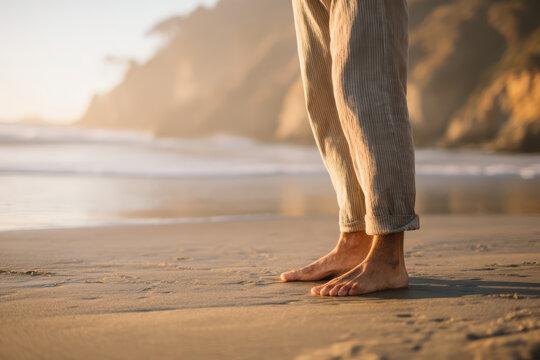 Man standing barefoot on sand beach focusing on grounding meditation technique in calm coastal therapy, stress management and holistic healing wellness. Mindfulness nature connection and mental health