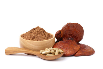 Reishi mushroom. Reishi mushroom powder capsules in wooden spoon and Reishi mushroom powder in wooden cups. isolated on white background.
