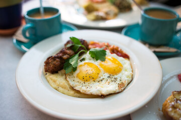 Sunny Side Up Eggs with Sausage and Grits
