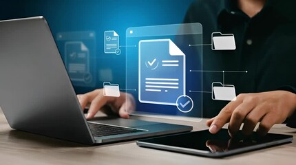A person using a laptop and tablet with a digital document icon, representing file management, data transfer, and modern technology in a business setting - Powered by Adobe