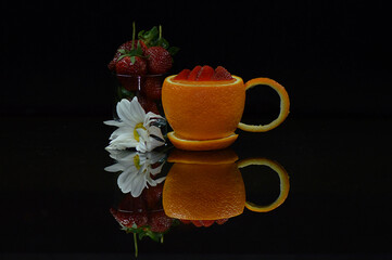 still life of orange, strawberry and flowers that resemble a cup shape give a special impression