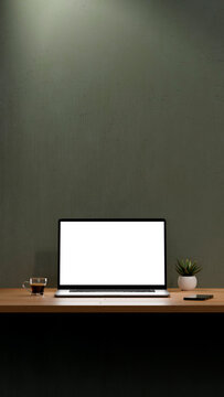 Blank screen of laptop for mockup. Workspace with computer, coffee cup, plant and mobile phone. 8k high resolution in Vertical format.