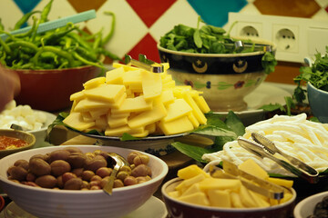 Cheese Platter With Olives and Fresh Herbs for a Party Feast