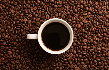 Close-up of Black Coffee Mug on Coffee Beans Surface