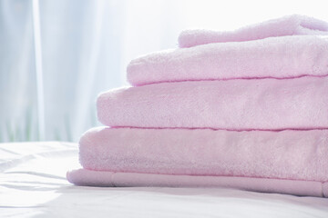 stack of towels on a bed with texture for background