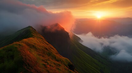 A stunning sunset over a mountain range with clouds forming a blanket over the valleys.