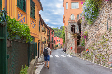 Narrow street with colorful buildings and stone walls in Portofino, Italy, Liguria region