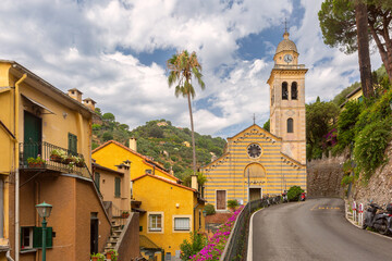 San Martino church with striped facade and bell tower in Portofino, Italy, Liguria region