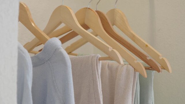 Organizing clothes on wooden hangers in a closet