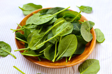 Spinach leaves on striped cloth.