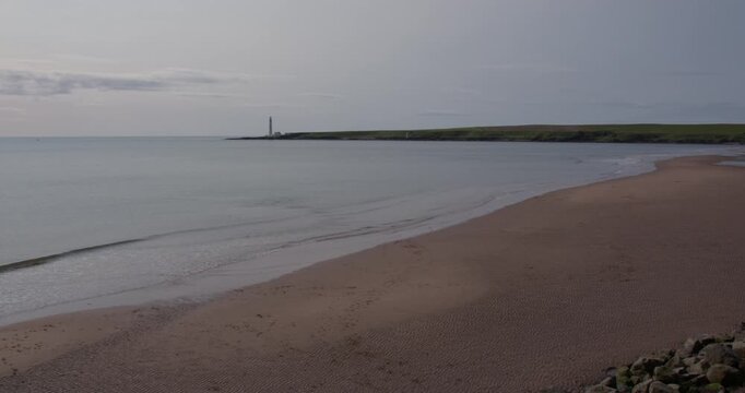 Extra wide shot of Montrose Beach with scurdie ness lighthouse.