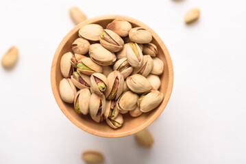 Roasted pistachios with salt, healthy snack on white background