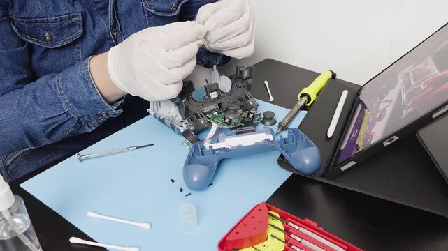 Electronic technician repairing broken video game controller