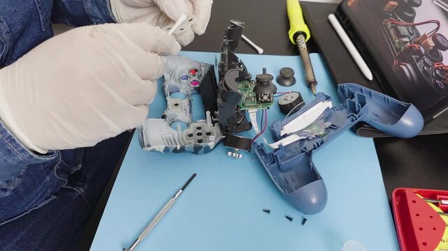Technician repairing disassembled video game controller