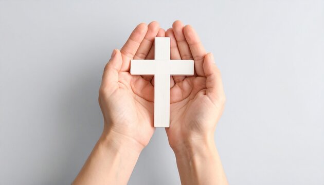 Hands Cradle a White Cross, Symbolizing Faith and Spiritual Devotion