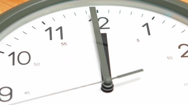 4K footage Time lapse Close-up wall clock showing the time exactly at twelve o'clock, symbolizing punctuality deadlines or new beginnings, Concept of precision and time awareness.