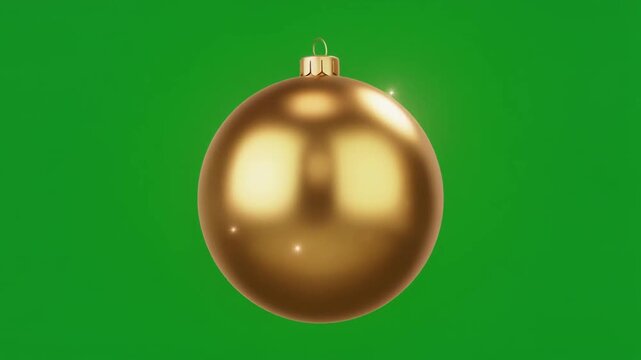 A shiny golden Christmas bauble against a vibrant green screen background, perfect for holiday season projects.