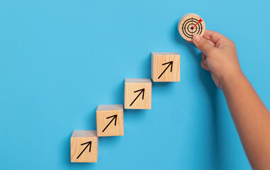 Business growth success achievement concept, hand arranging wooden block stacking as step stair or ladder for planning development leadership and customer target group concept.