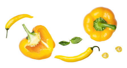 grouping of fresh yellow vegetables including a whole bell pepper, halved capsicum, and vibrant yellow chili peppers with basil leaves photograph.