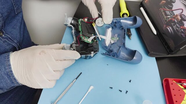 Technician repairing a broken video game controller
