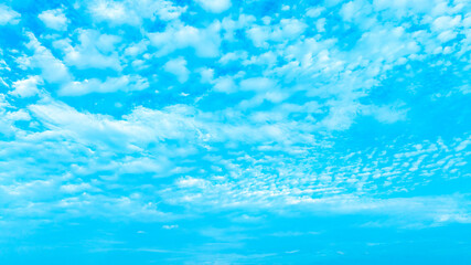 A bright, clear blue sky meets a glowing white horizon, suggesting a serene, open, and with sunlight of beautiful cloudy sky. landscape or abstract background.
