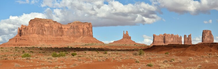 Landscape of Monument Valley in Arizona, showing the Saddleback Butte, King on His Throne, Stagecoach Butte, and Castle Rock.