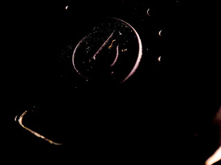 Abstract shapes of dark outlines emerge from darkness, creating a moody and mysterious atmosphere.